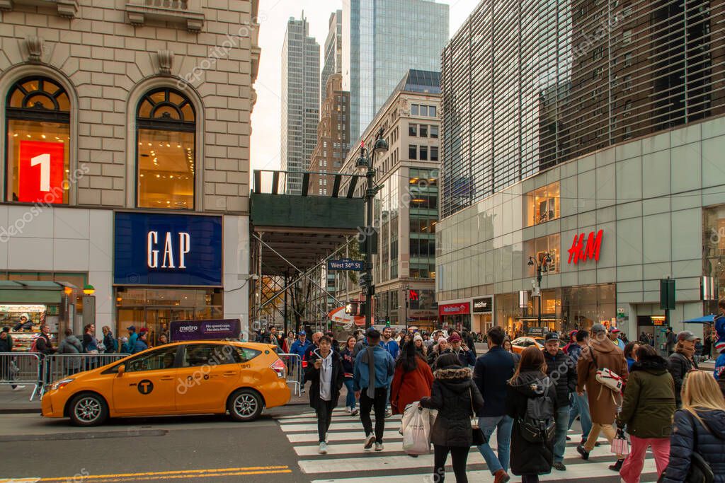 New York, USA. 11 10 2019. Cityscape of the streets of downtown Manhattan. People and cars at the intersection of 6th Ave and W 34th St.