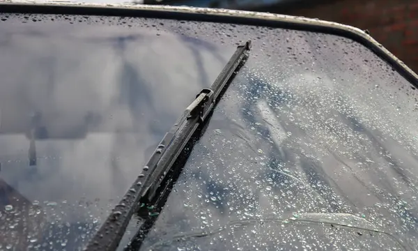 Car wipers wipe raindrops from the car windows