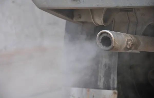 thick smog from the exhaust fumes of an old car. car exhaust gases close-up.