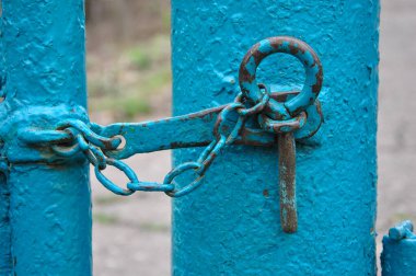 old metal latch with a chain on the gate