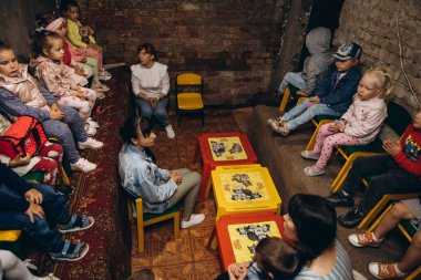 07.07.22 Irpin, Ukraine: evacuation of  children during the Russian war against Ukraine. The family is hiding in the dungeon from air strikes