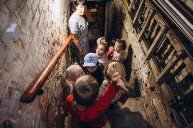 07.07.22 Irpin, Ukraine: small children and their caregivers are evacuated to an underground cellar used as a shelter during an air raid