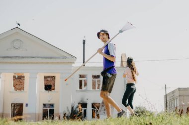 06.08.2022 Irpin, Ukraine:  a group of volunteers is moving in the direction of the house destroyed by the Russian troops to carry out dismantling and restoration of the lost housing