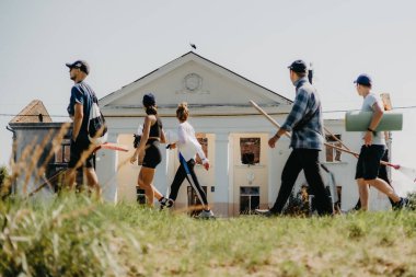 06.08.2022 Irpin, Ukraine:  a group of volunteers is moving in the direction of the house destroyed by the Russian troops to carry out dismantling and restoration of the lost housing