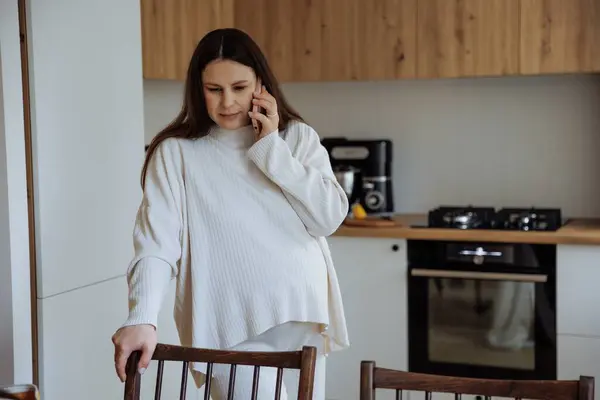 Беременная Женщина Разговаривает Телефону Кухне Дома Лицензионные Стоковые Изображения