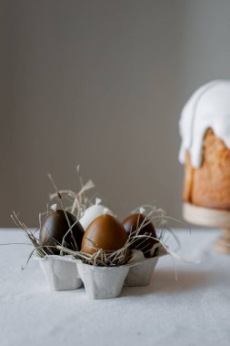 Paskalya pastaları ve şenlikli dekorlarla estetik ve şık bir masa. Paskalya pastası, Paskalya yumurtaları, mumlar. Boşluğu kopyala