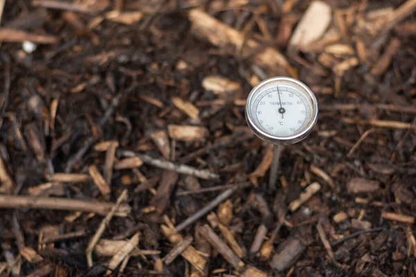 stock image Immature compost managed in a community composter placed in a common area to recycle the organic waste from the town apartments with one thermometer to control the process. Concept of recycling and sustainability