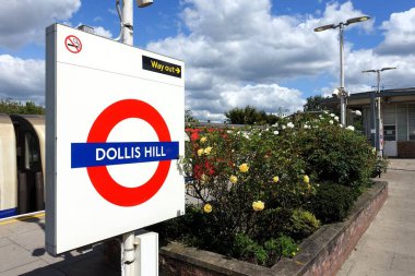 Dollis Hill station Transport for London roundel sign on the platform clipart