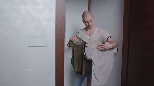 Bald Young Man Holding Hangers Clothes High Quality Footage — Vídeos de Stock