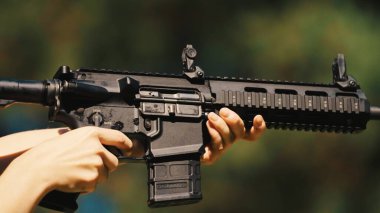 Hands of a man holding a gun carbine. High quality photo