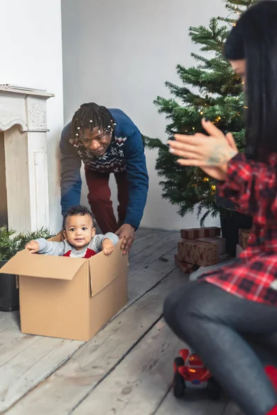 Father Pushing His Toddler Son Cardboard Box Floor High Quality — Φωτογραφία Αρχείου