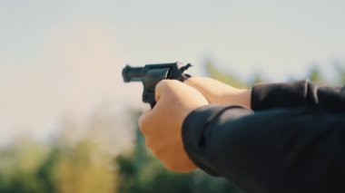 Hands of a man shooting a pistol with a revolving cylinder. High quality 4k footage