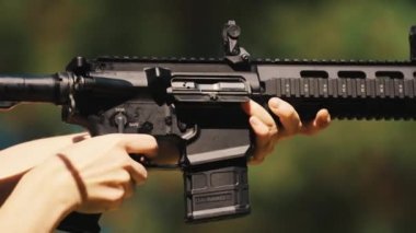 Closeup of a gun carbine during shooting, ejecting empty bullet casings. High quality 4k footage