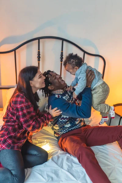 Smiling Multiracial Family Three Cuddling Playing Bed High Quality Photo — Stockfoto
