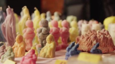 Handmade colorful sculptural candles on the table. High quality 4k footage