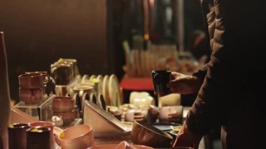 People looking at handcrafted ceramic crockery at the handcraft market. High quality 4k footage