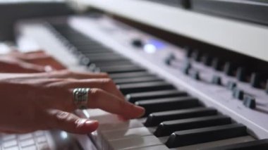 Close up view of female hands playing electric piano. High quality 4k footage