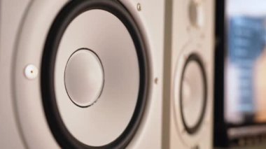 White studio monitors vibrating, playing music. High quality 4k footage