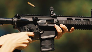 Burst fire from an automatic rifle. Continuous firing of bullets. Used in combat. High quality photo