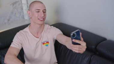 excited bald gay man talking in a live video, medium shot LGBT concept. High quality 4k footage