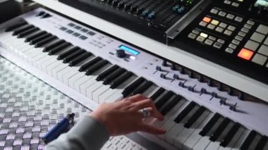 Top view of male musician hands playing synthesizer at home studio. High quality 4k footage