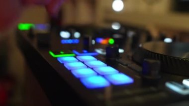 Closeup of a man making music beats and sounds with a drum pad neon light machine. High quality 4k footage