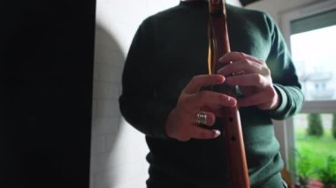 A man musician playing native American style flute. No face. High quality 4k footage