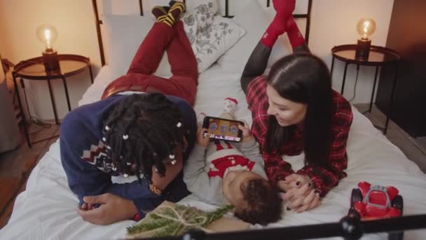 Lovely Couple Laying Bed Little Son Playing Phone Christmas Time — Stock Video