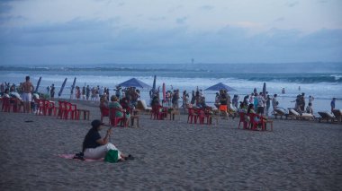 bali, indonesia - 1 5 december 2 0 1 9 : people enjoying a beautiful sunset on the beach