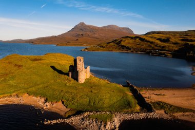 View of the ruined 16th century Ardvreck Castle over Loch Assynt, Sutherland, north west Highlands, Scotland clipart