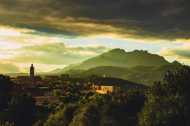 View of a Esparreguera town at sunset, with montserrat in the background.