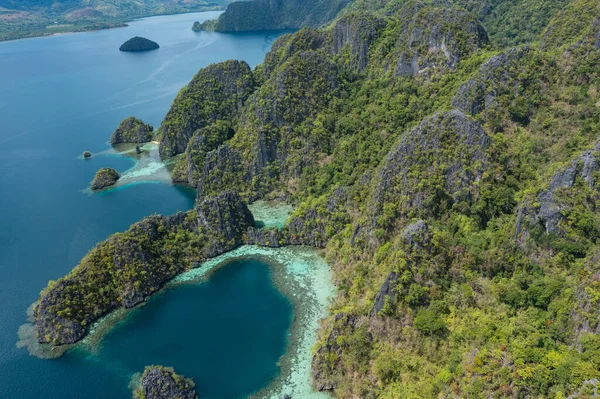 Kayangan Gölü yakınlarındaki Coron Adası 'nın göl manzarası güneşli bir günde tipik Filipinli teknelerle dolu.