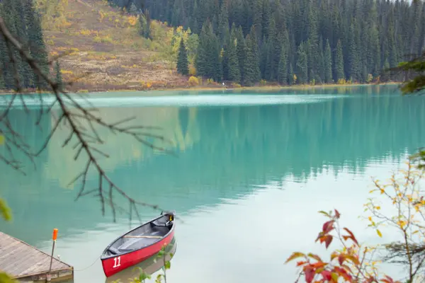Small red boat on an autumn day on Emerald Lake, Yoho, Canada.
