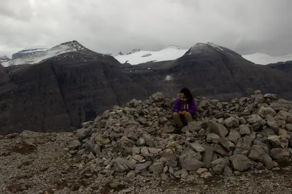 stock image Woman hiker in a wind shelter high on a mountain in the Canadian Rockies.