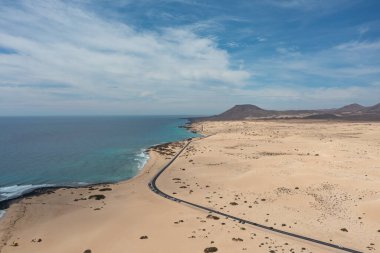 İspanya 'nın Kanarya Adaları Fuerteventura kentindeki Corralejo Doğal Parkı' ndan geçen yolun yüksek çözünürlüklü hava fotoğrafı.. 