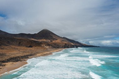 Kahve Sahili 'nin manzaralı manzarası, altın kum tepeleri ve arka planda Roque del Moro..