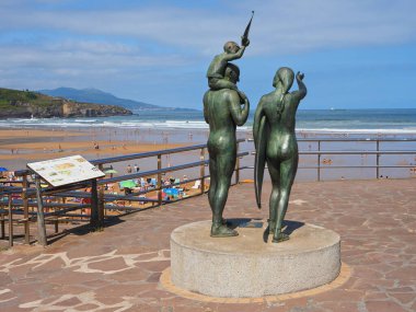 Bronze sculpture of people on the beach clipart