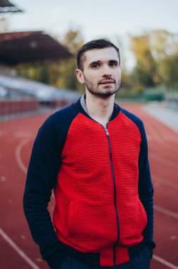 a portrait of a man in a red jacket