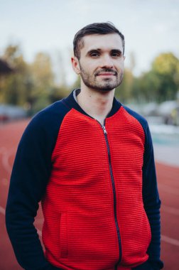 a portrait of a man in a red jacket