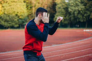 a man in a sweatshirt boxing alone