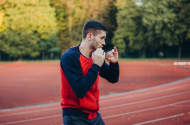 a man in a sweatshirt boxing alone