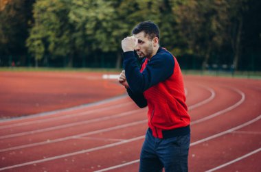 a man in a sweatshirt boxing alone