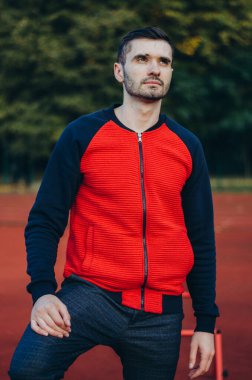 a portrait of a man in a red jacket