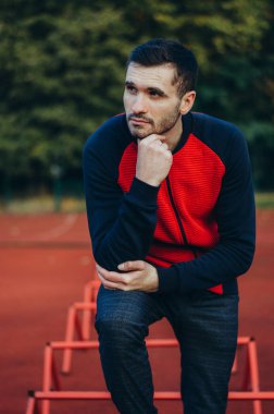 a portrait of a man in a red jacket