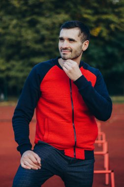 a portrait of a man in a red jacket