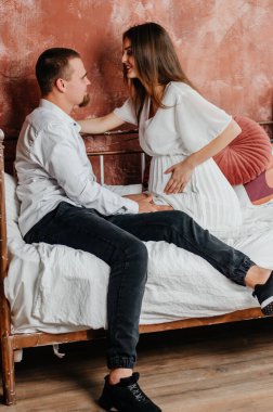 pregnant woman with man in bed