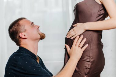 a man talks to his baby in the mother's tummy