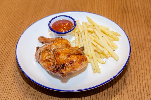 A plate with chicken and fries