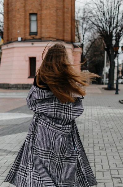 stock image Woman walking on the street in a coat