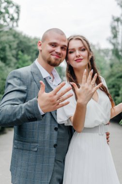 Gelinler parmaklarında alyans gösteriyor.